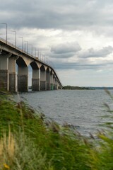 Vertical selective focus of a road bridge over Kalmar Strait with a cloudy sky in the background © Tomas Torsén/Wirestock Creators