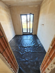 Laying insulation on the floor of a newly built house