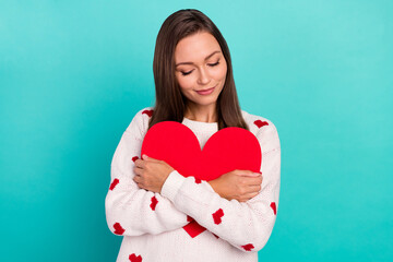 Photo of lovely cute lady closed eyes hands hold embrace red paper heart isolated on teal color background
