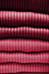 Handmade knitting wool texture background. New 2023 trending PANTONE Viva magenta colour