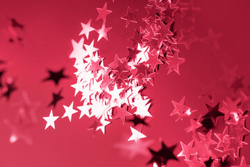 Fototapeta na wymiar Shiny viva magenta stars glitter or confetti. Festive holiday backdrop and pattern. Via magenta color trendy 2023 background.