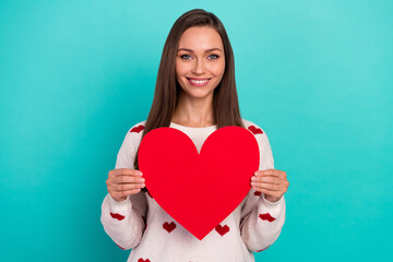 Photo of positive adorable lady hands hold big red paper heart card isolated on emerald color background