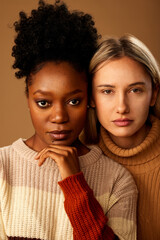 Portrait of multicultural girls posing in studio while looking at the camera.
