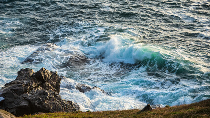 Stunning sunset landscape image of Cornwall cliff coastline with tin mines in background viewed from Pendeen Lighthouse headland