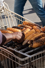 Grilled corn on the cob for sale at the exit of the metro and in front of the major French monuments in Paris by corn sellers
