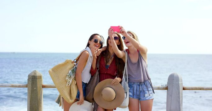 Phone selfie, ocean and woman with friends standing on path at sea on summer adventure in Sydney. Friendship, freedom and travel, happy women on vacation taking picture with smartphone in Australia.