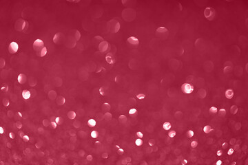Festive abstract blurred glitter background magenta color.