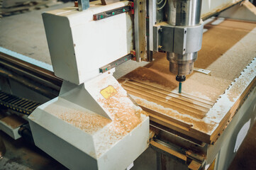 Close shot of a drilling cnc machine at wood machining industry