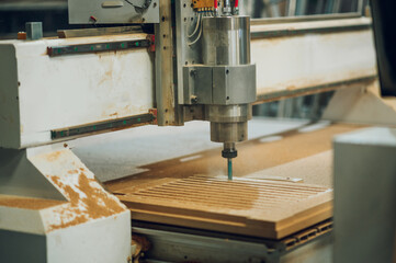 Close shot of a drilling cnc machine at wood machining industry