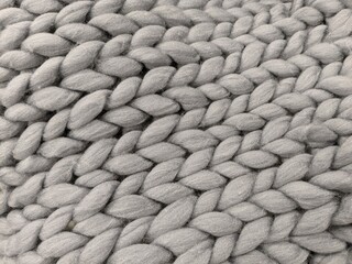 gray wool knitted plaid with a large braid for backgrounds
