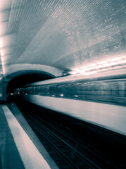 Passage of the Paris metro with blur effect revealing the speed of the arriving and departing metro