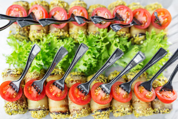 close-up of delicious appetizers with tomatoes and stuffed eggplants in a delivery box