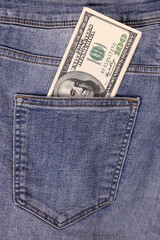 Banknot of hundred of US dollar in pocket of jeans. The concept of savings, investment, earnings. inheritance. Vertical Orientation