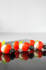 close-up of a delicious snack with tomatoes, mozzarella cheese and olives. Copy space