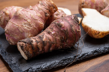 Group of fresh uncooked topinambur or Jerusalem artichoke roots