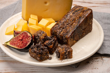Cheese collection, old Dutch cheese with holes, made in the Netherlands served with fresh figs, figs bread with chocolate