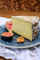 Pieces of cheese tomme de montagne or tomme de savoie made from cow milk in French Alps