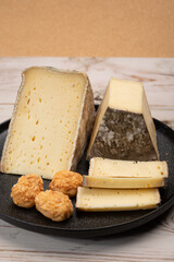 Pieces of cheese tomme de montagne or tomme de savoie made from cow milk in French Alps