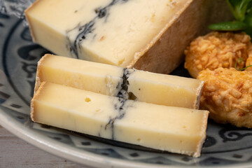 French semi-soft cow milk cheese morbier from Franche-Comte region with thin black layer and strong aroma