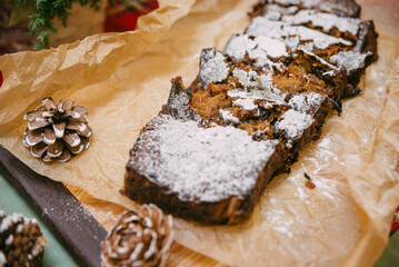 Christmas cake with dried fruit sprinkled with powdered sugar