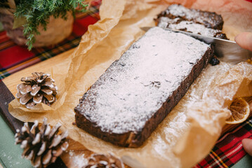 Christmas cake with dried fruit sprinkled with powdered sugar