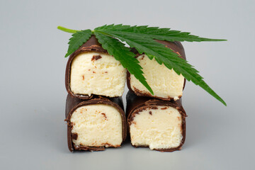 green marijuana leaf and chocolate sweet covered milk cheese with cannabis oil