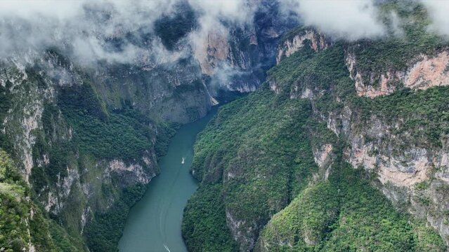 Aerial view of the majestic Canyon del Sumidero in Mexico. Flight over the canyon in the clouds.