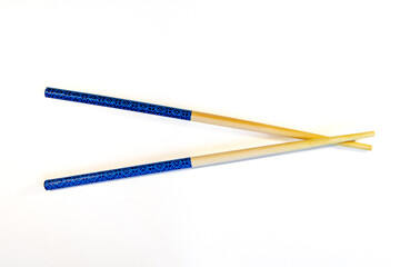 Two Chopsticks crossed on white background