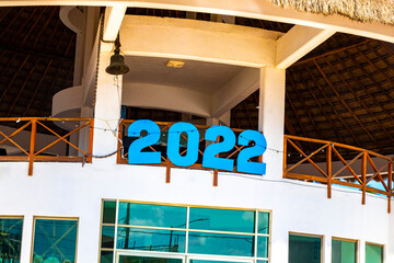 2022 sign on building at port harbor ferries Chiquilá Mexico.