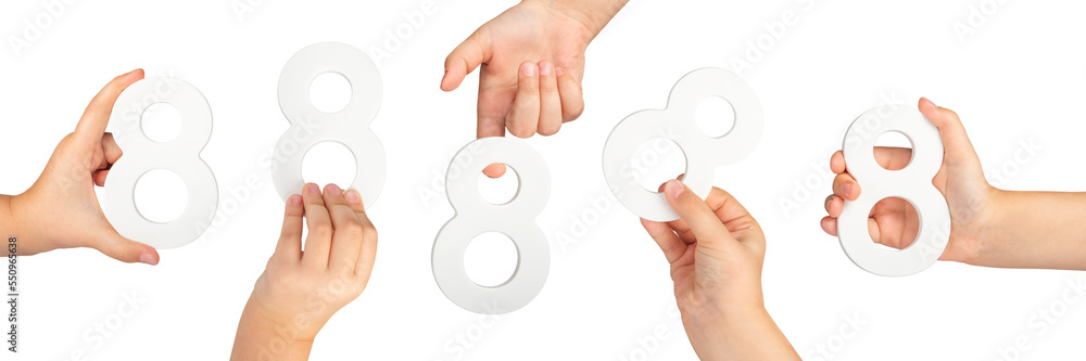Fototapete Number eight in hand isolated on black background. Number 8 in a child's hand is held on a black background. A large set of hands with the number eight to insert into a project or design.