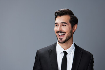 Portrait of a business man with a natural smile with teeth on a gray background in a business suit. Business portrait of a stylish man copy space