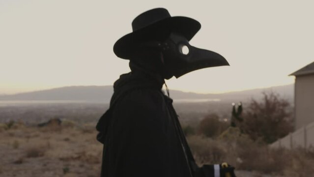 Tracking shot of person walking wearing plague doctor costume / Cedar Hills, Utah, United States