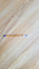 blue plastic pen on wooden background