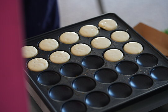Making mini pancakes on the pancake machine in the morning.