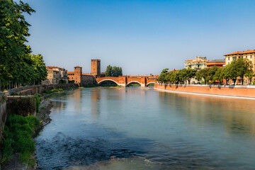 View of Adige river and medieval stone bridge of Ponte Scaligero in Verona, built in 14th century near Castelvecchio. Italy.