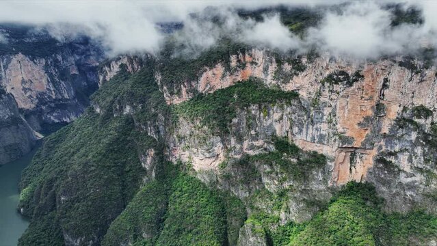 Aerial view of the majestic Canyon del Sumidero in Mexico. Flight over the canyon in the clouds.