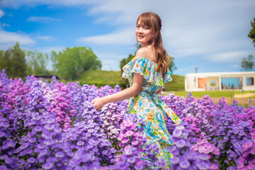 woman wearing a long dress in a field of margaret flowers exudes a relaxed and freedom. Soft and select focus