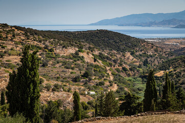 Fototapeta na wymiar View of the hillsides extending to the Aegean Sea outside of the town of Lefkes, on the island of Paros.