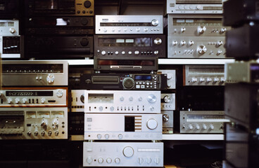 a lot of audio equipment on the shelves
