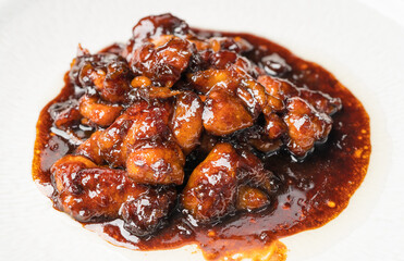 Teriyaki chicken nuggets on a dark background