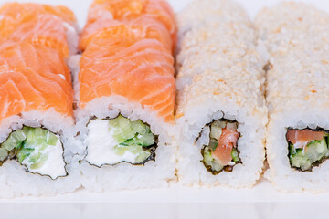 Japanese food rolls in sesame with salmon, cucumber, Philadelphia cheese. Food delivery.