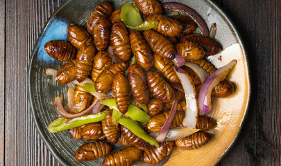 Stir-fried cocoon pupae is a special food in northeast China