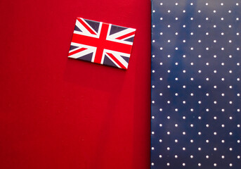 Holiday design and luxury branding, British flag on red and blue polka dot flatlay background makes...