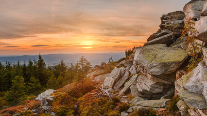 Eastern Sudetes, mountain landscape, rocky trail on the hiking trail leading to the top of Czarna Gora. The trail is lit by the setting sun.