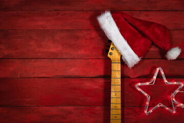 Electric guitar with red Santa Claus hat. Christmas music concept.