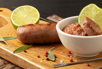 Brazilian spicy sausage on cutting board. Selective focus.