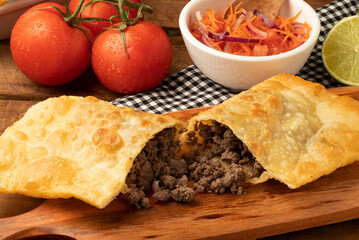 Brazilian pastel stuffed with minced beef. Selective focus.