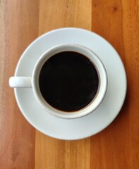 A cup of black coffee on wooden table
