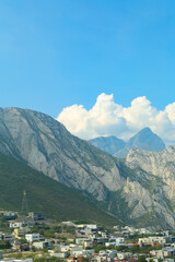 Small town near majestic mountain landscape covered with greenery