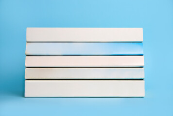 Collection of books on light blue background